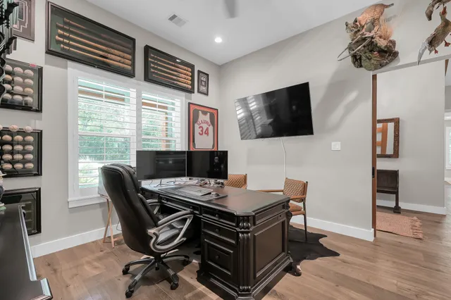 a view of a workspace with furniture and a flat screen tv