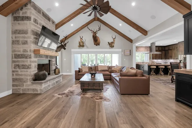 a living room with furniture a fireplace and a flat screen tv