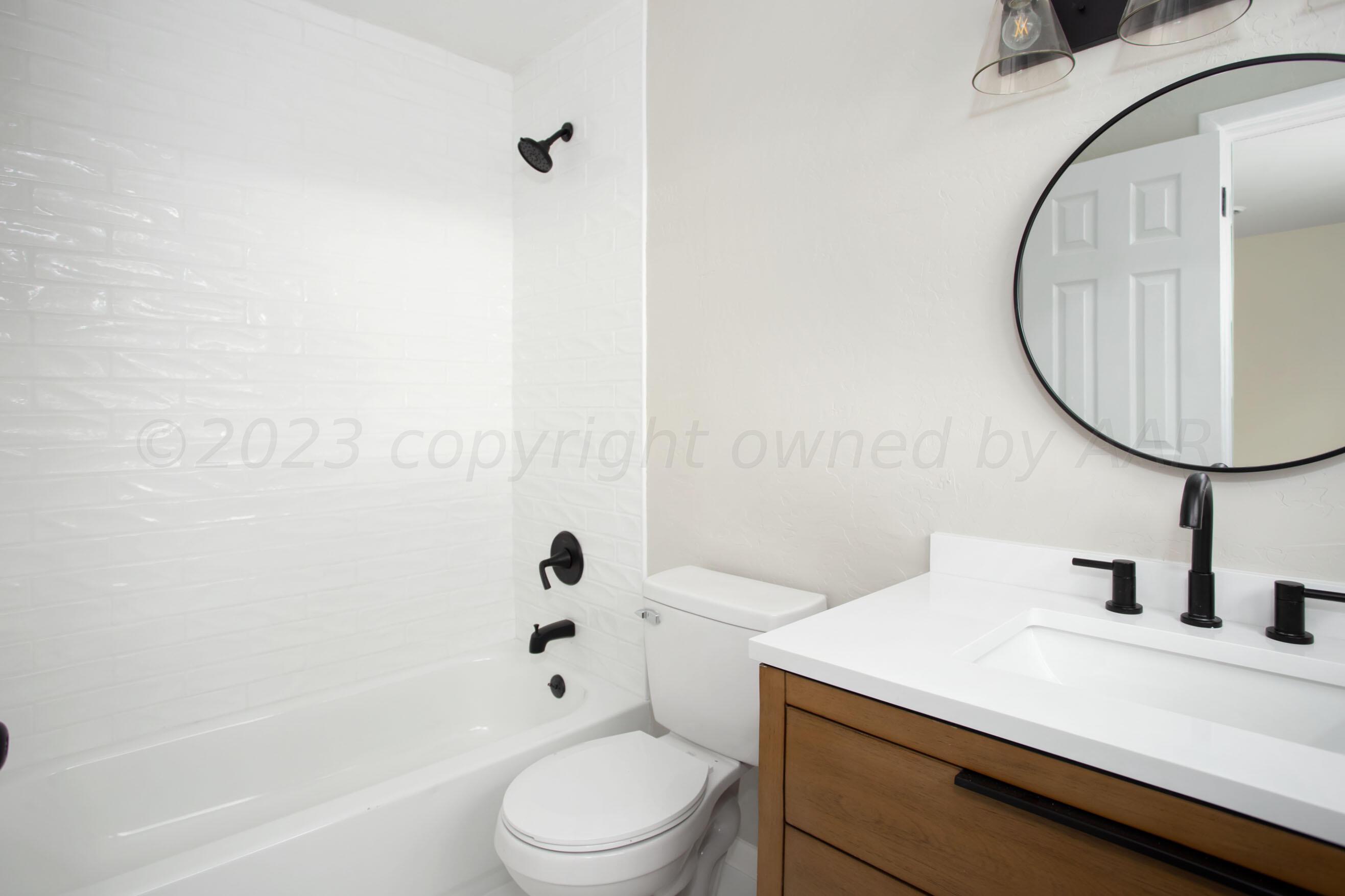 3624 Sunlite Street Amarillo, TX 79109 - Photo 16 of 25 a bathroom with a sink a toilet and shower