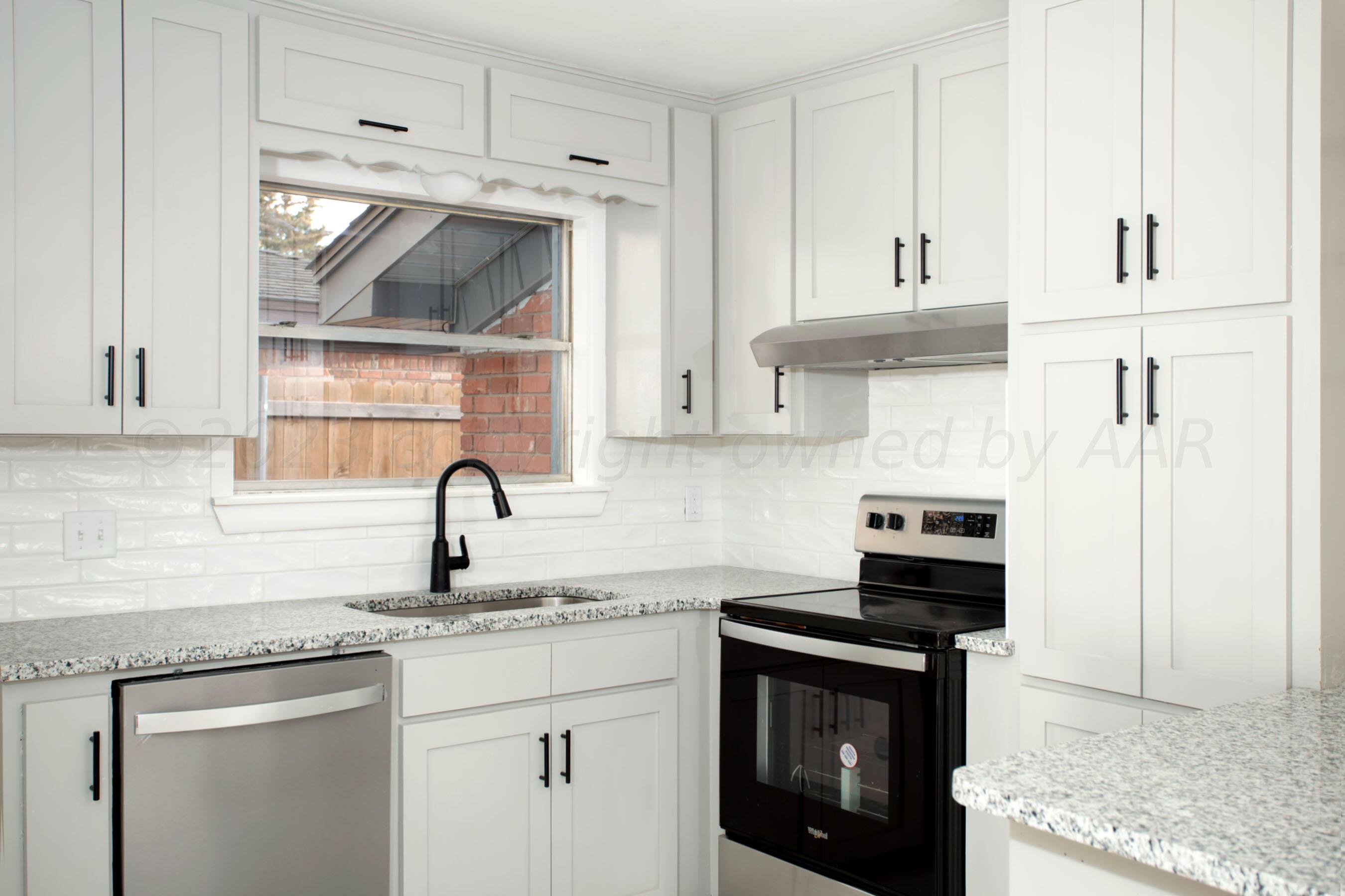 3624 Sunlite Street Amarillo, TX 79109 - Photo 6 of 25 a kitchen with stainless steel appliances granite countertop a sink stove and cabinets