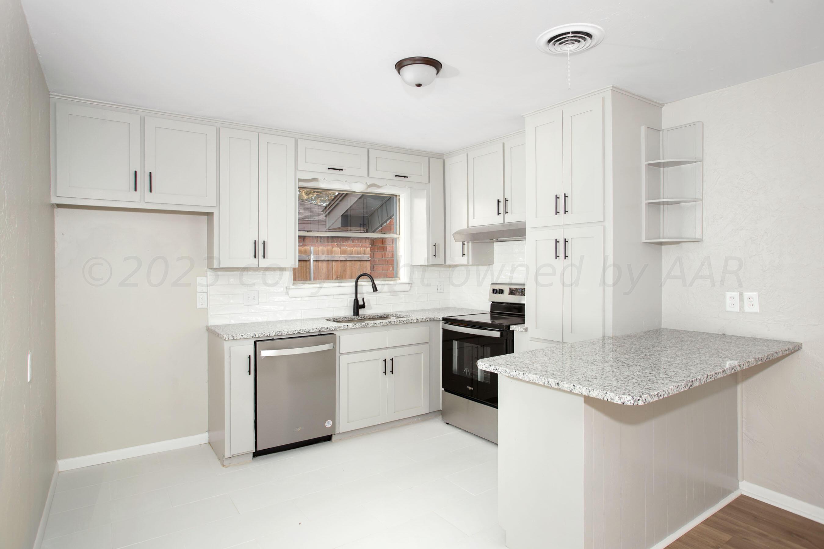 3624 Sunlite Street Amarillo, TX 79109 - Photo 7 of 25 a kitchen with stainless steel appliances granite countertop a sink stove and refrigerator