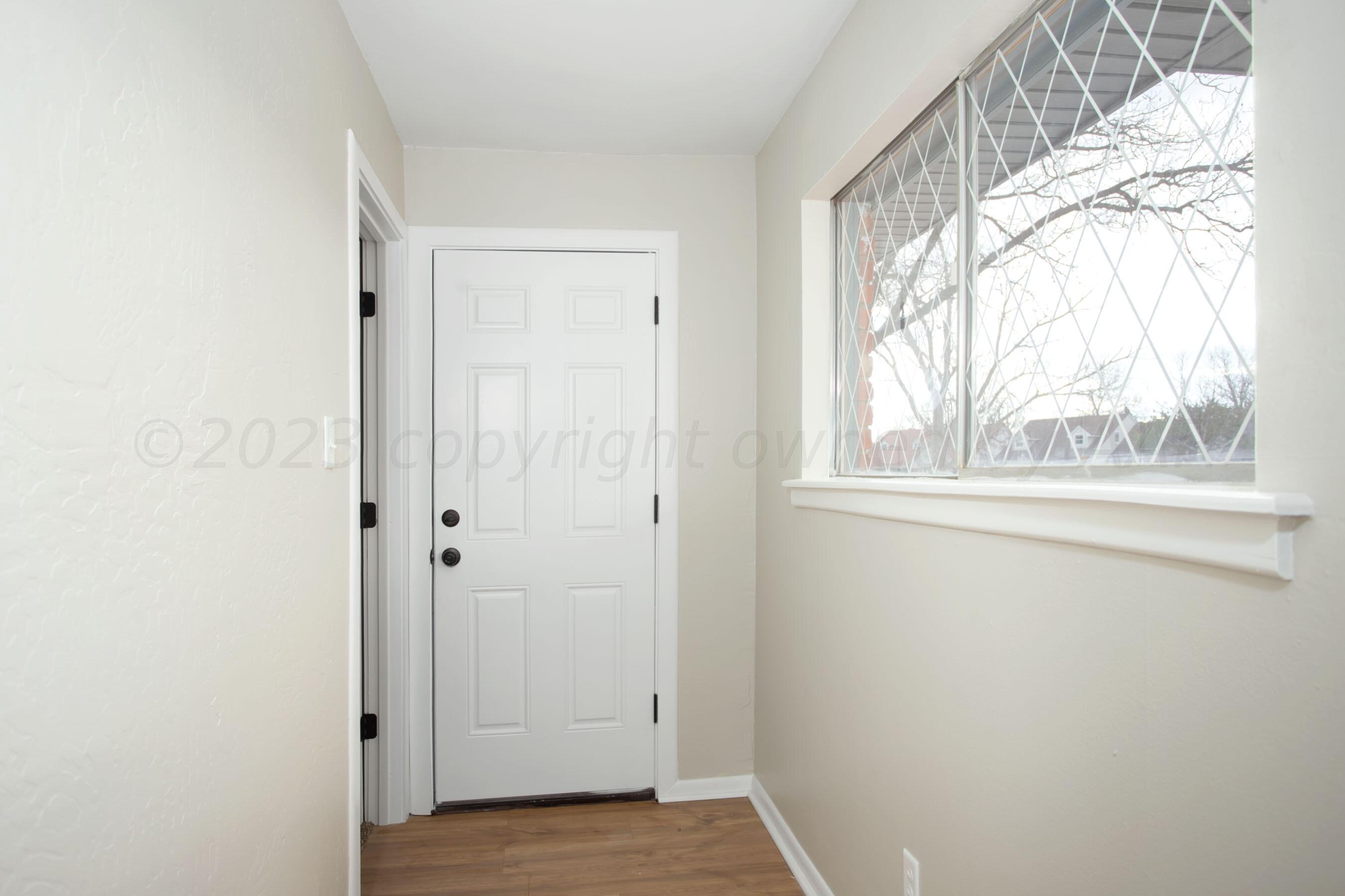 3624 Sunlite Street Amarillo, TX 79109 - Photo 8 of 25 a view of an empty room with wooden floor and a window