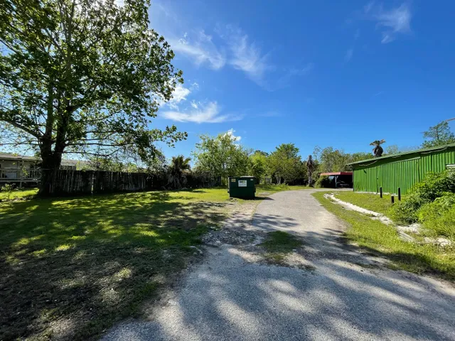 a view of a field with trees in the background