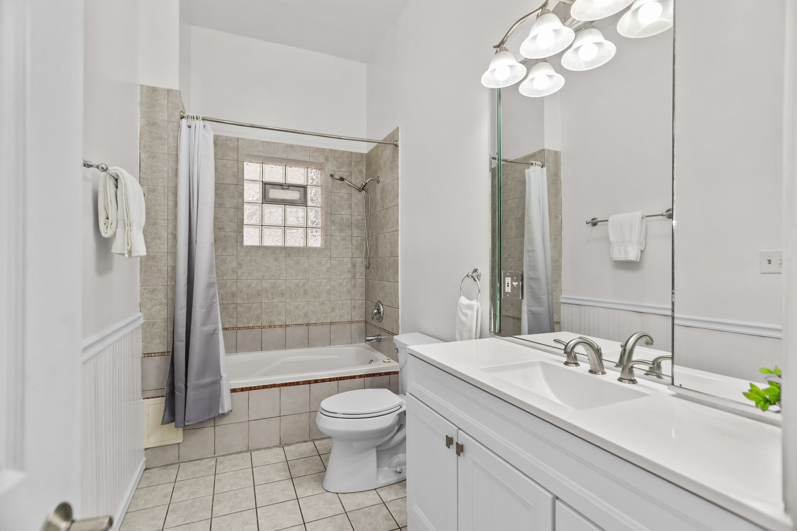 2247 West Monroe Street, Unit 3 Chicago, IL 60612 - Photo 13 of 31 a bathroom with a granite countertop sink a toilet and shower