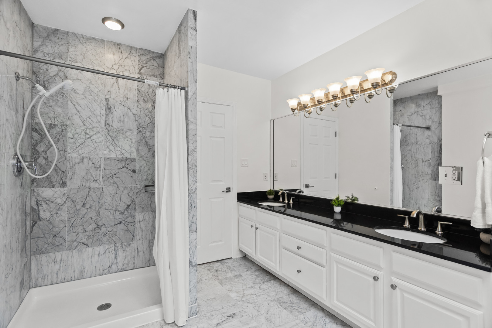 2247 West Monroe Street, Unit 3 Chicago, IL 60612 - Photo 23 of 31 a bathroom with a double sink shower and a mirror