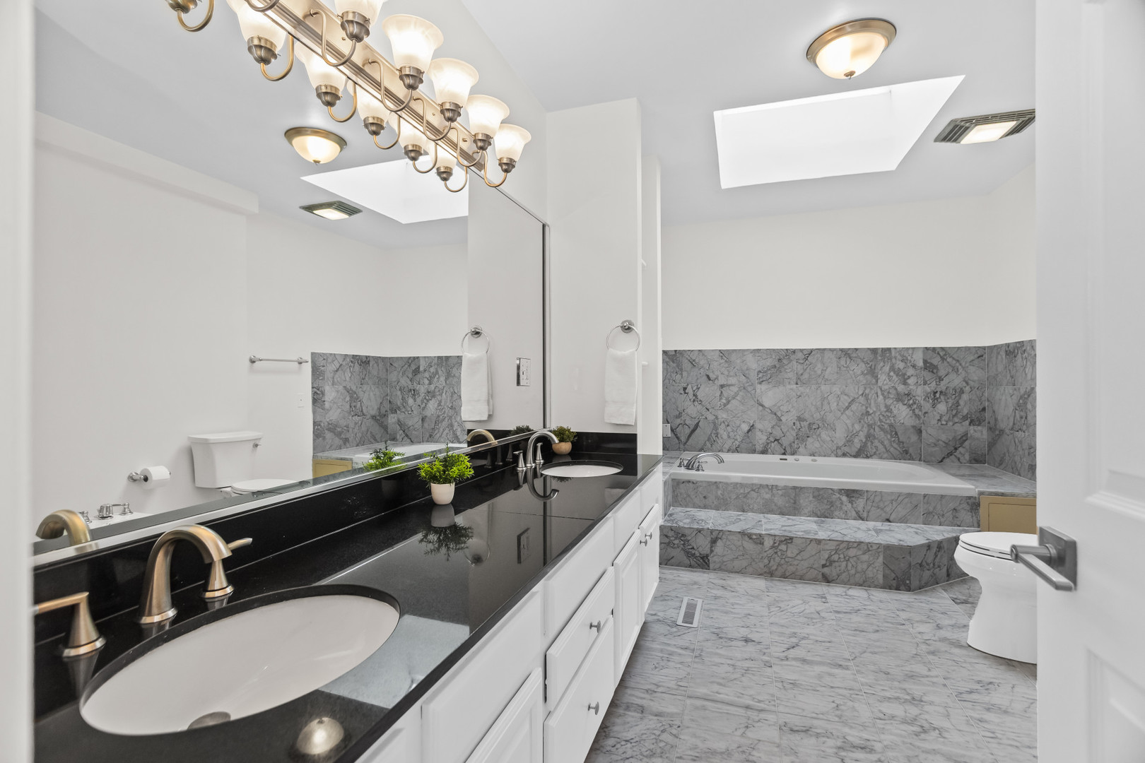 2247 West Monroe Street, Unit 3 Chicago, IL 60612 - Photo 24 of 31 a bathroom with a granite countertop double vanity sink and a mirror