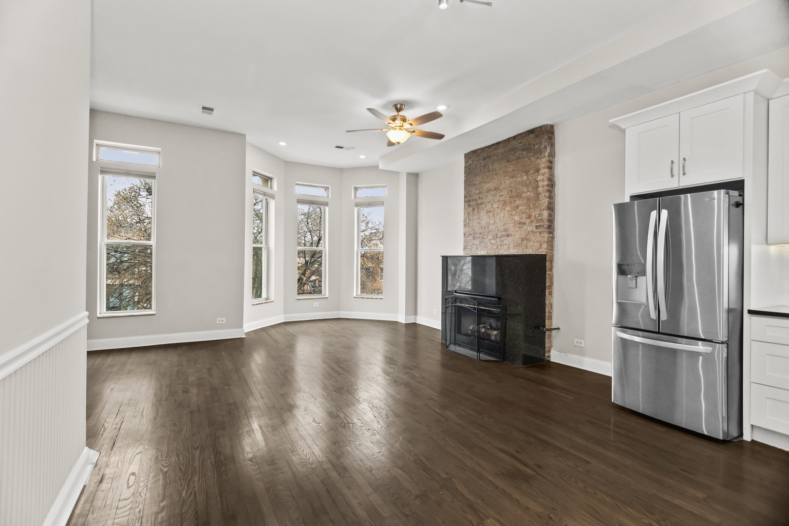 2247 West Monroe Street, Unit 3 Chicago, IL 60612 - Photo 3 of 31 a view of a kitchen with wooden floor fridge and a window