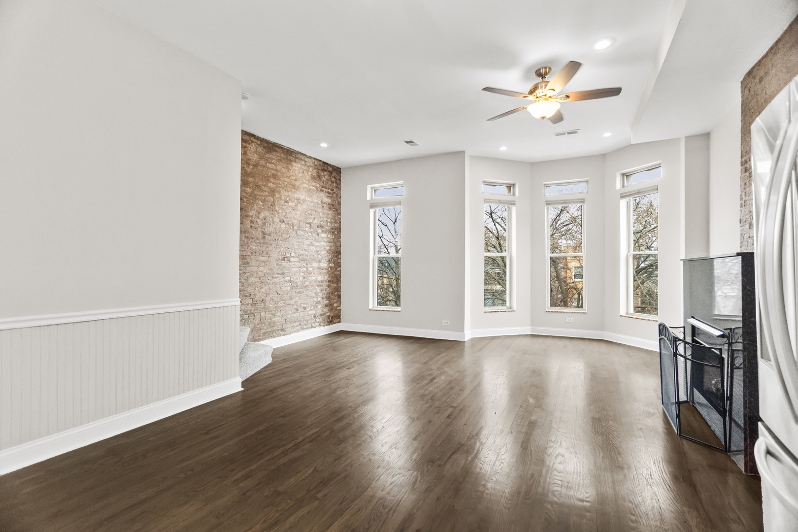 2247 West Monroe Street, Unit 3 Chicago, IL 60612 - Photo 6 of 31 a view of an empty room with wooden floor and a window