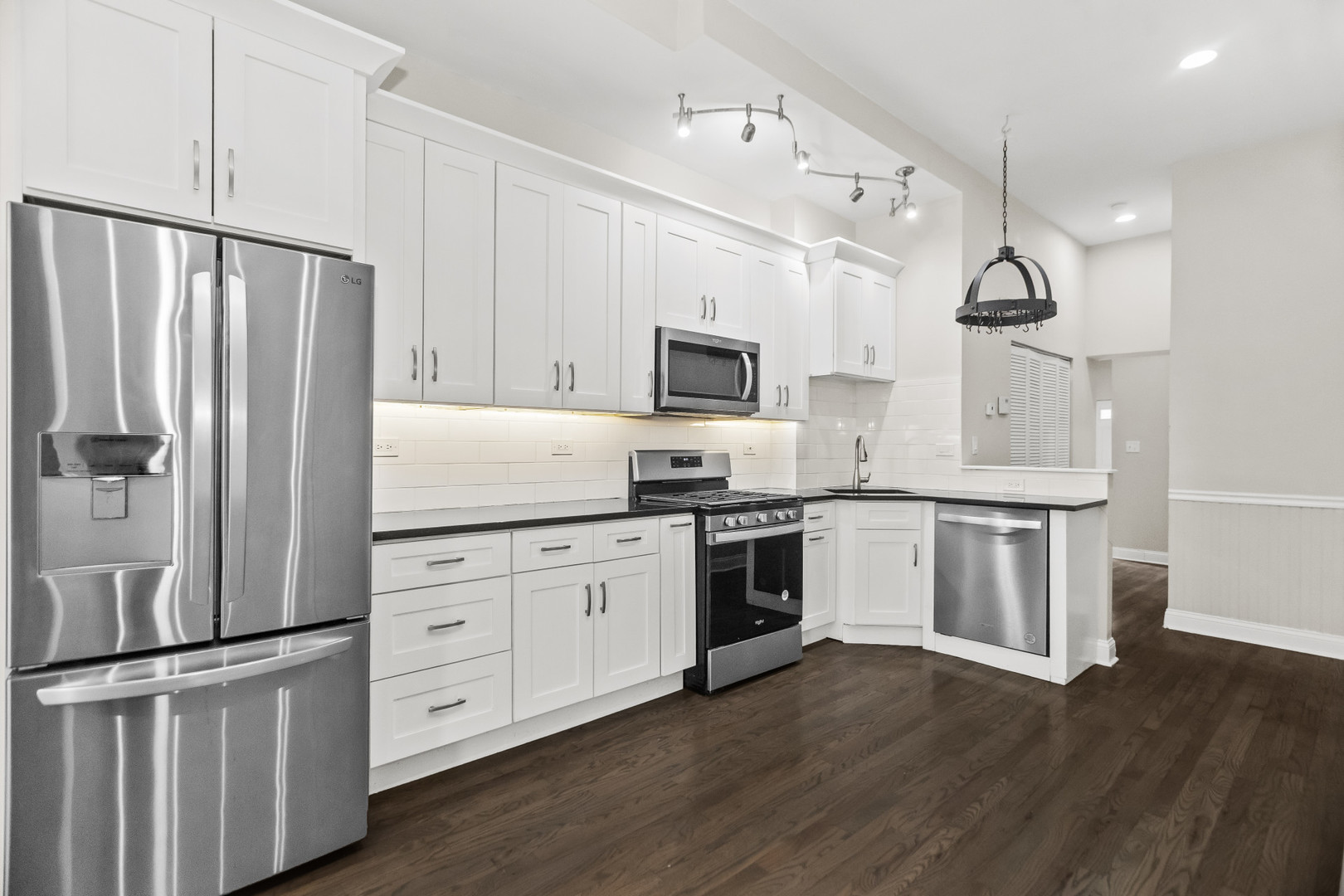 2247 West Monroe Street, Unit 3 Chicago, IL 60612 - Photo 8 of 31 a kitchen with granite countertop a refrigerator oven a sink and white cabinets