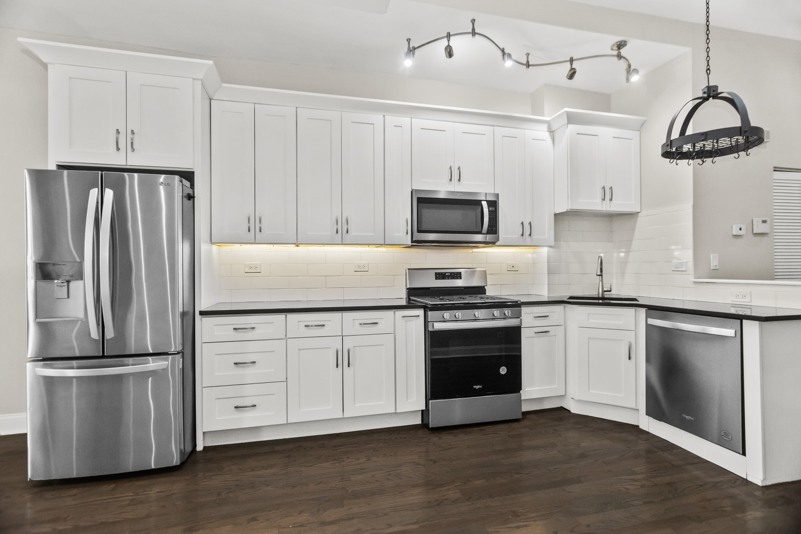 2247 West Monroe Street, Unit 3 Chicago, IL 60612 - Photo 9 of 31 a kitchen with granite countertop a refrigerator stove and microwave