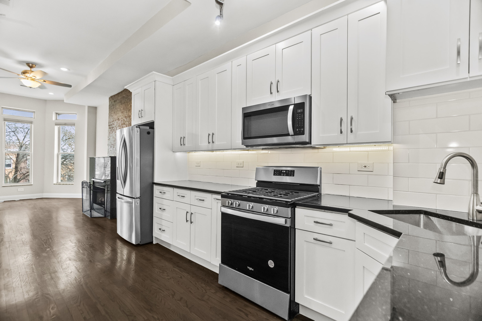 2247 West Monroe Street, Unit 3 Chicago, IL 60612 - Photo 10 of 31 a kitchen with cabinets stainless steel appliances and wooden floor