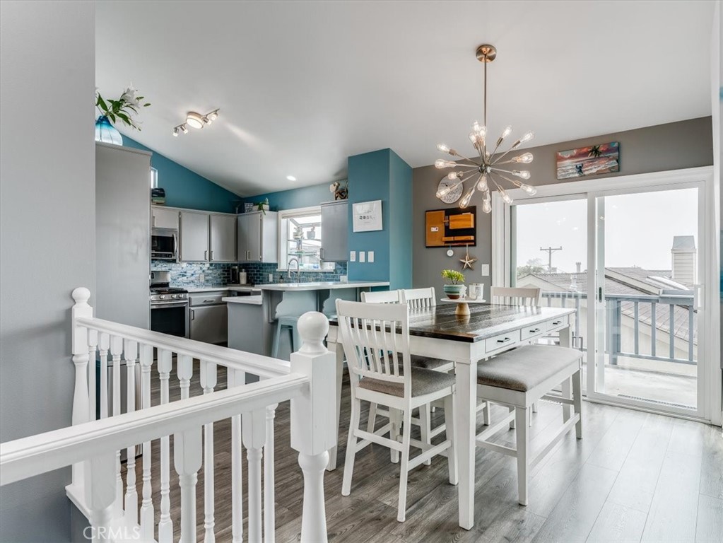 554 Cambridge Street Cambria, CA 93428 - Photo 15 of 52 a view of a dining room and livingroom with furniture wooden floor kitchen view and a chandelier