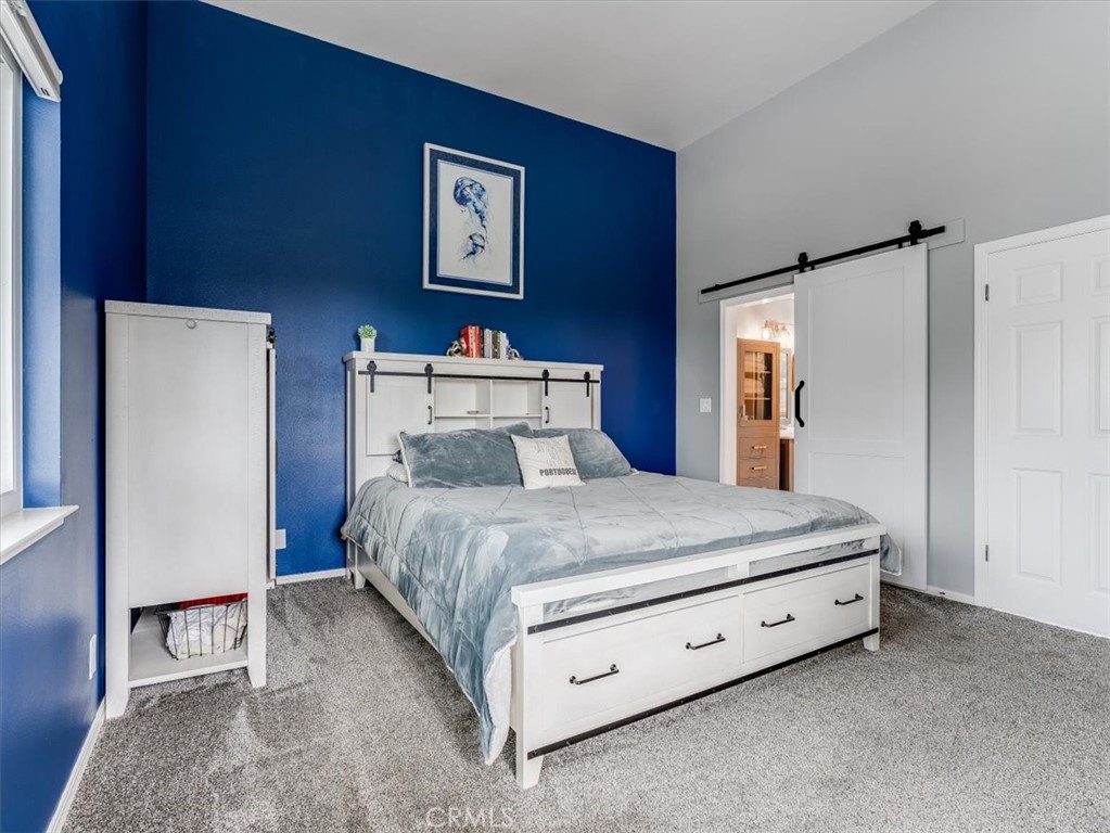 554 Cambridge Street Cambria, CA 93428 - Photo 26 of 52 a bedroom with a bed and a refrigerator