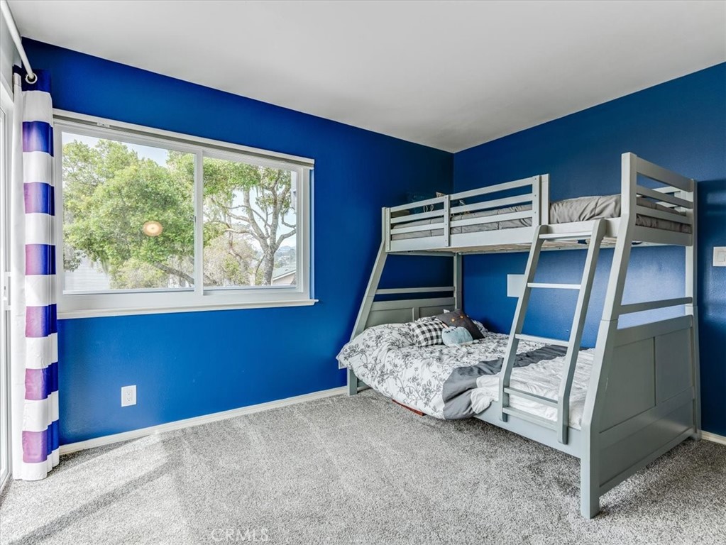 554 Cambridge Street Cambria, CA 93428 - Photo 32 of 52 a bedroom with a bed and a window