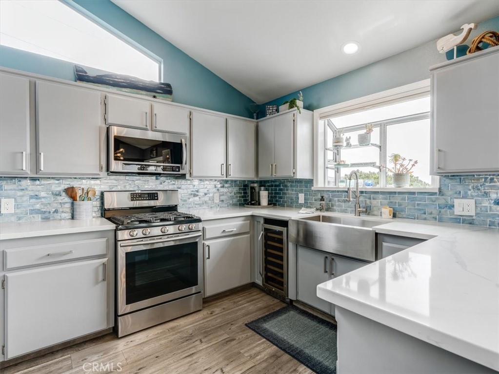 554 Cambridge Street Cambria, CA 93428 - Photo 4 of 52 Quartz countertops and glass tile backsplash are found in the gorgeous kitchen.