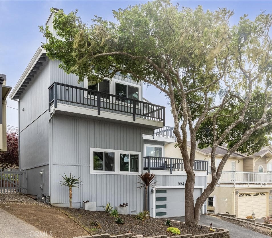 554 Cambridge Street Cambria, CA 93428 - Photo 7 of 52 a front view of a house with trees