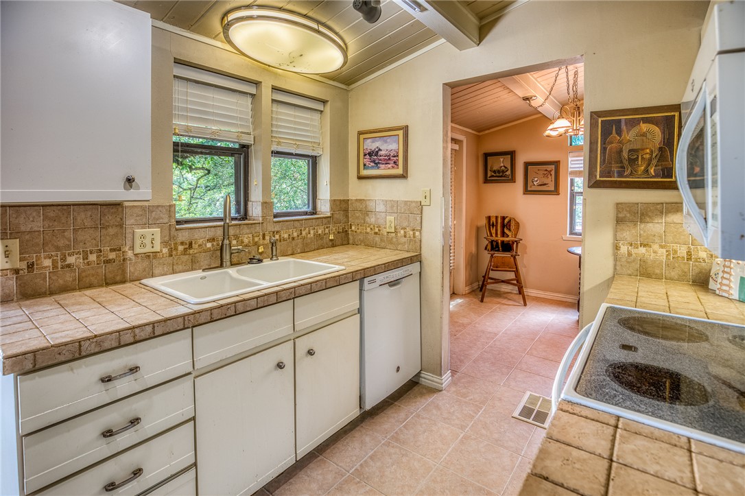 2330 County Road 329 Milano, TX 76556 - Photo 24 of 45 a spacious en suite bathroom with a granite countertop sink mirror and vanity