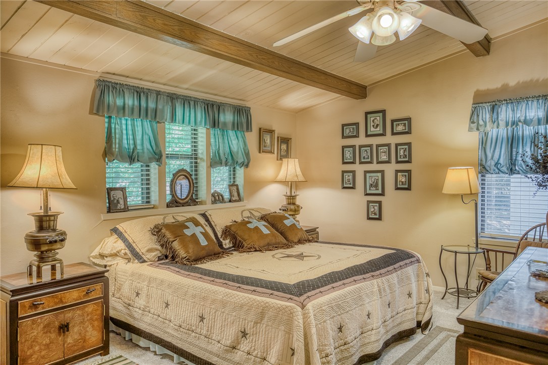 2330 County Road 329 Milano, TX 76556 - Photo 27 of 45 a bedroom with a bed and a night stand next to a window