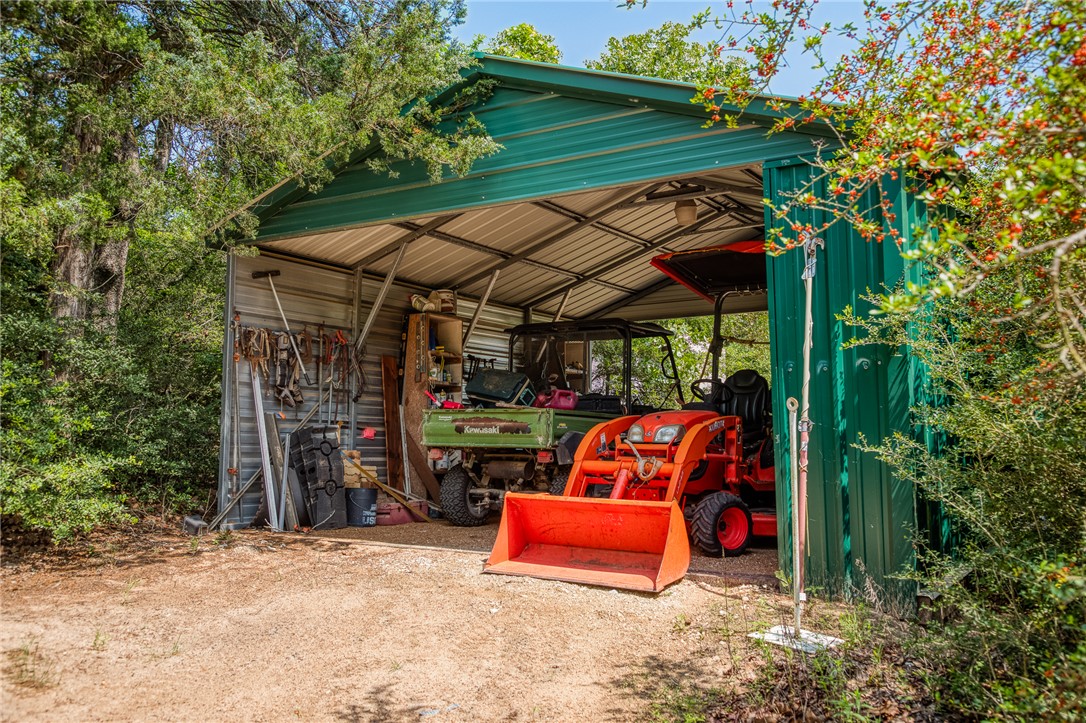 2330 County Road 329 Milano, TX 76556 - Photo 29 of 45 an outdoor sitting area with a table and chairs under an umbrella