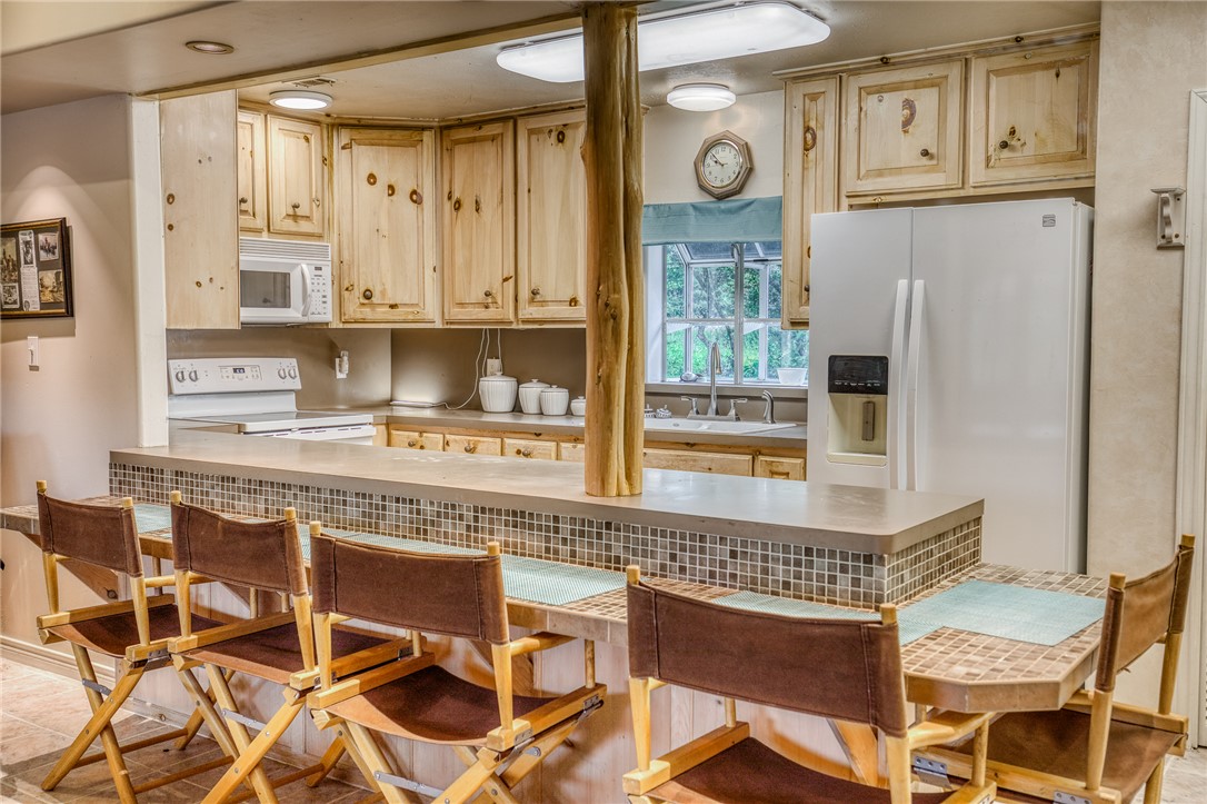 2330 County Road 329 Milano, TX 76556 - Photo 9 of 45 a kitchen with stainless steel appliances granite countertop a refrigerator and cabinets