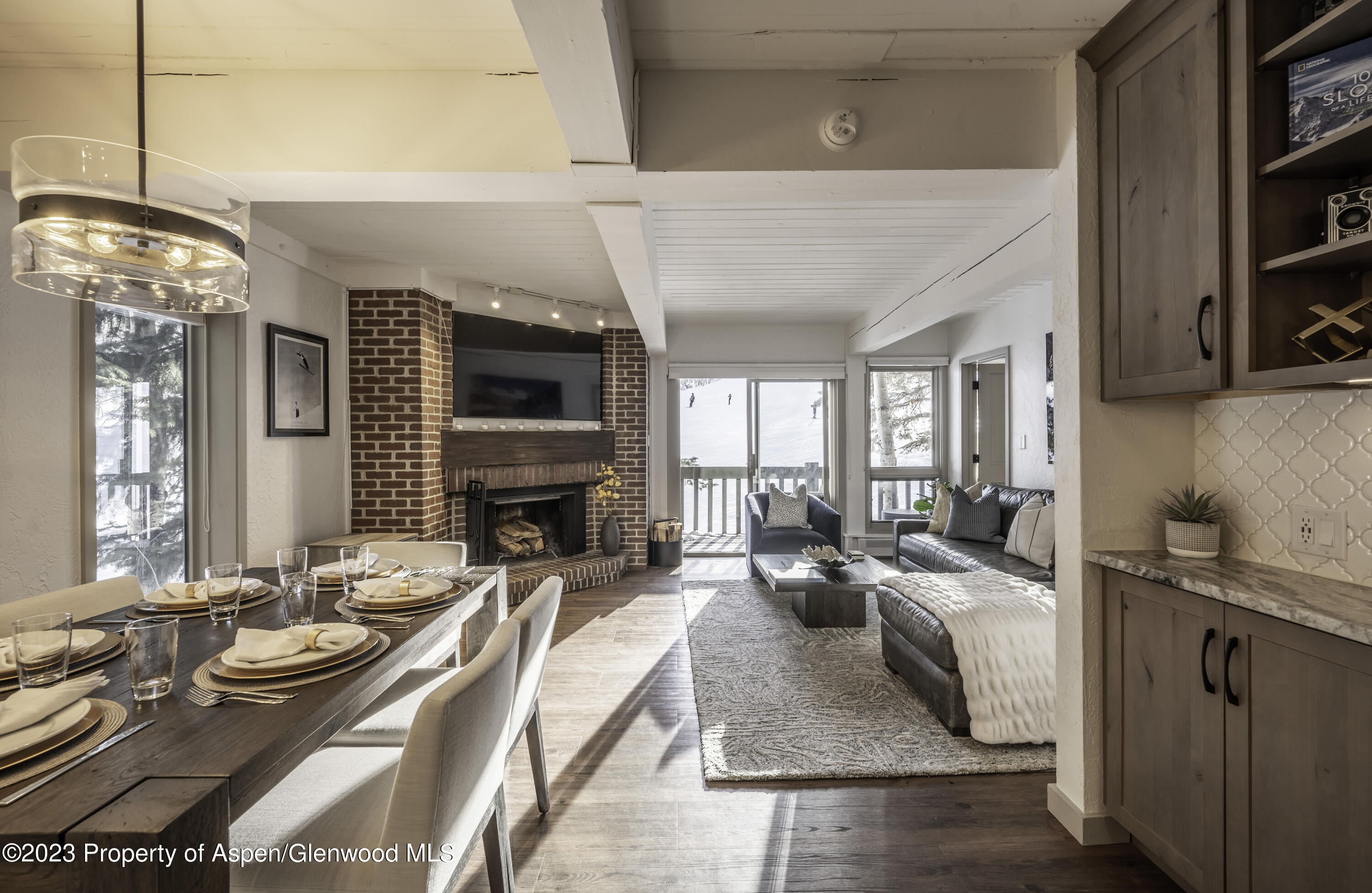 a living room with fireplace furniture and a flat screen tv