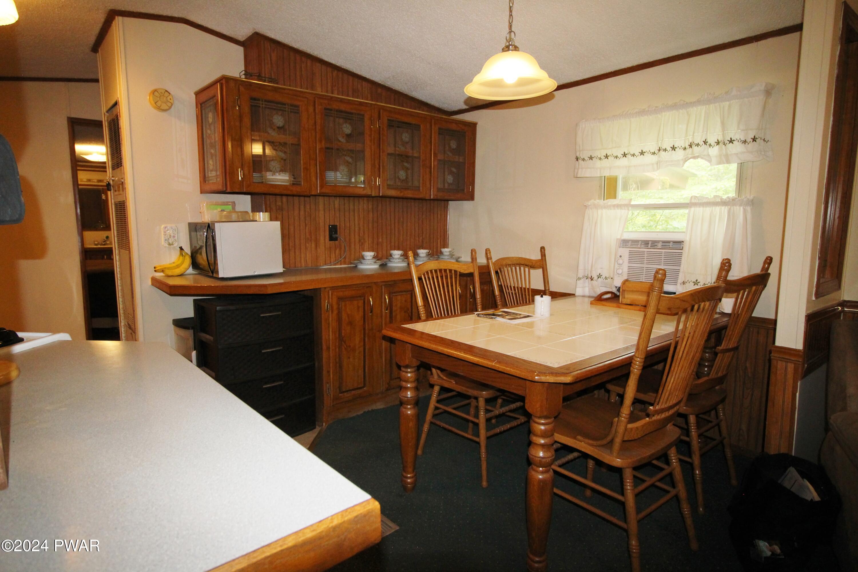 10 Madison Estate Moscow, PA 18444 - Photo 4 of 45 a kitchen with a table chairs a sink dishwasher and cabinets