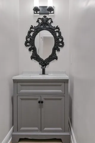 a kitchen with stainless steel appliances granite countertop a sink a stove a refrigerator and island with wooden floor