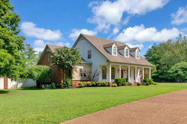 a kitchen with kitchen island a counter top space a refrigerator and a sink
