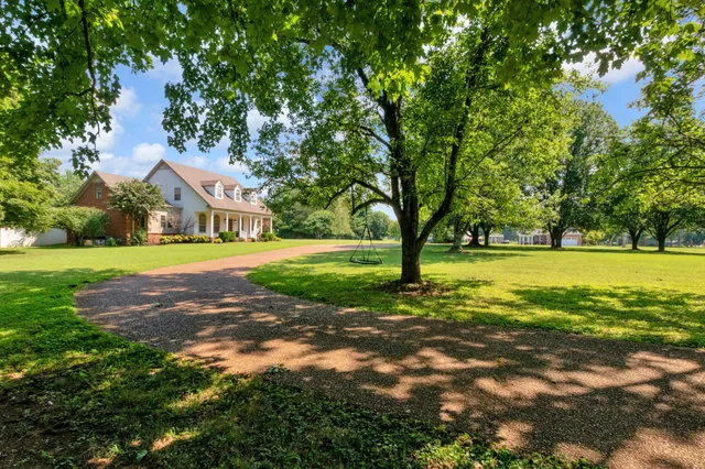 a kitchen with stainless steel appliances granite countertop a refrigerator a sink and a stove