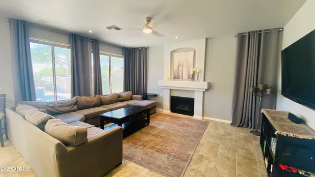 a living room with fireplace furniture and a flat screen tv