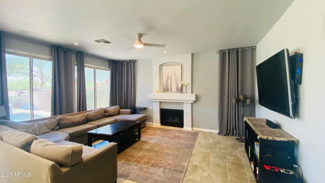 a living room with furniture fireplace and flat screen tv