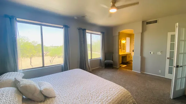 a bedroom with a bed and a chandelier