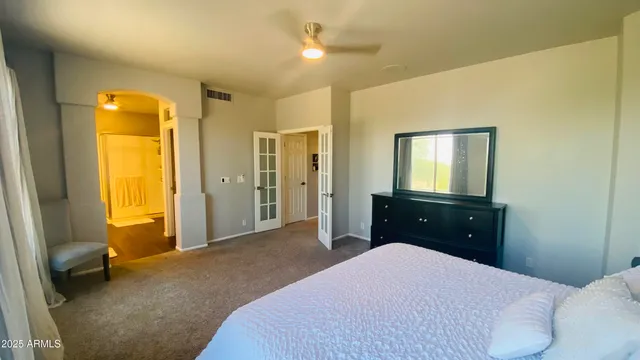 a bedroom with a bed and a chandelier