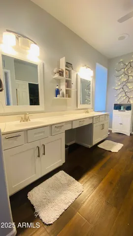 a spacious bathroom with a sink a mirror and a bathtub