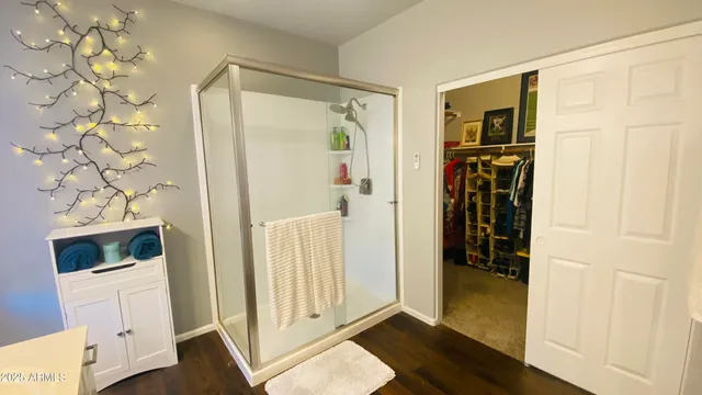 a view of walk in closet with clothes and shoes