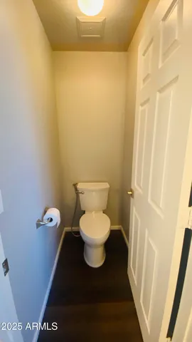 a bathroom with a toilet and a mirror