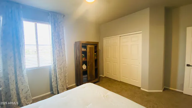 a bedroom with a bed and a window