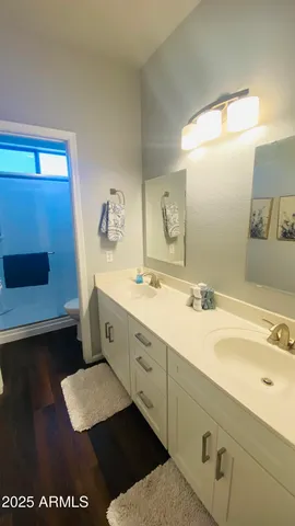 a bathroom with a sink a toilet and a mirror