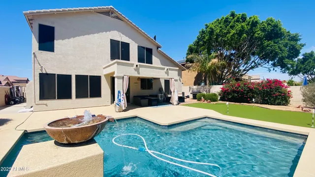 a front view of a house with swimming pool and porch