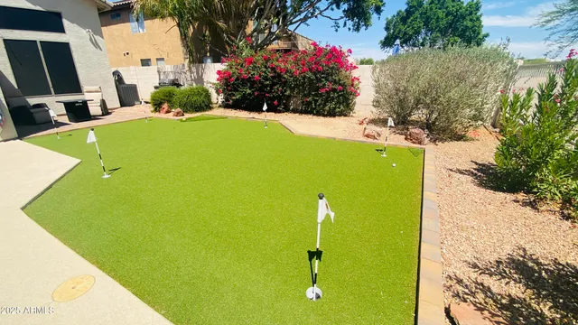 a view of a house with a backyard