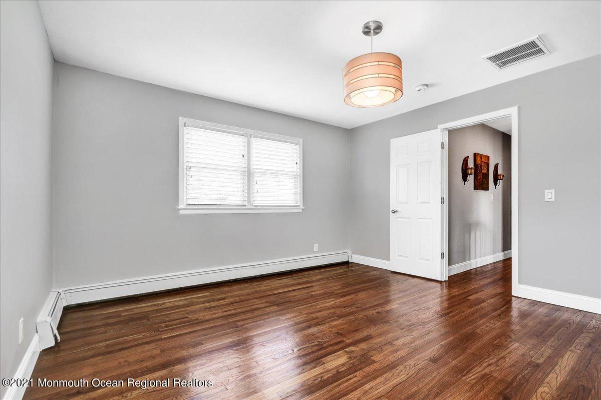 129 Jordan Road Brick, NJ 08724 - Photo 22 of 45 an empty room with wooden floor and a window