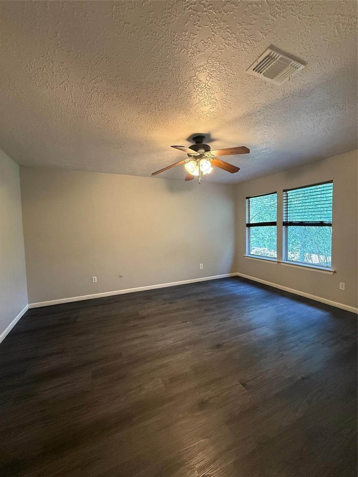 17 Briervine Court Spring, TX 77381 - Photo 15 of 19 a view of an empty room with wooden floor and a window