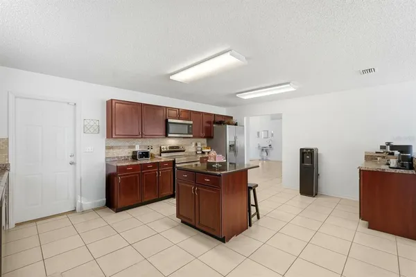 a kitchen with stainless steel appliances a stove a refrigerator and cabinets