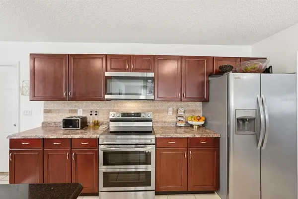 a kitchen with granite countertop a sink cabinets and a window