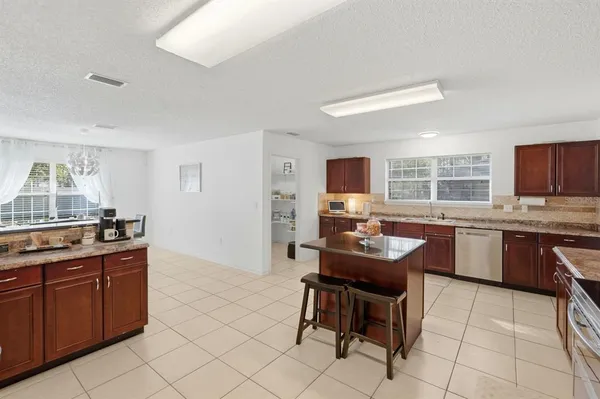 a kitchen with stainless steel appliances kitchen island granite countertop a sink and cabinets