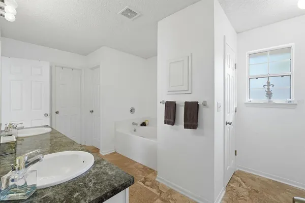 a bathroom with a glass shower door and a shower