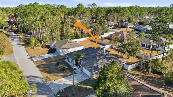 an aerial view of a house with a yard basket ball court and outdoor seating