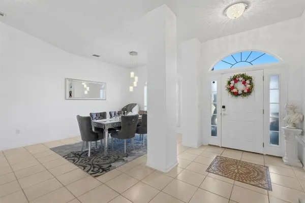 a dining room with furniture and a chandelier