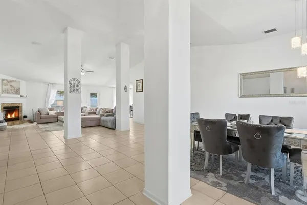 a view of a dining room with furniture a chandelier and wooden floor