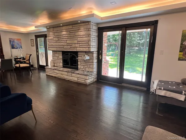 a view of a livingroom with furniture wooden floor and a fireplace